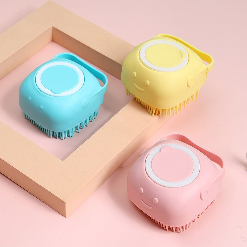 Three colorful scalp massagers on a pink background